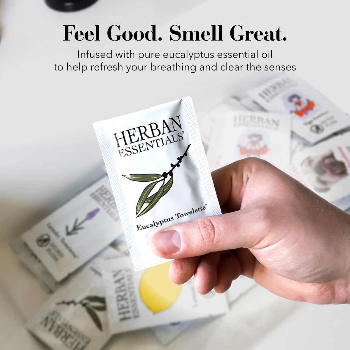 Herban Essentials wipe beside a hand to show size and coverage benefit