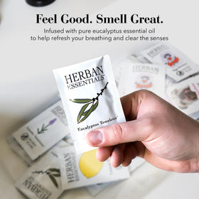 Herban Essentials wipe beside a hand to show size and coverage benefit