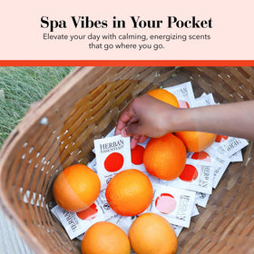 Herban Essentials wipe beside a credit card showing compact travel size convenience