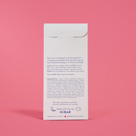 HIBAR curl shampoo bar on a bathroom shelf with towel, depicting plastic-free lifestyle benefit