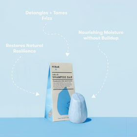 HIBAR shampoo bar in hand showing compact travel-friendly size