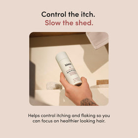 hims bottle in hand dispensing product to show user-friendly squeeze and control