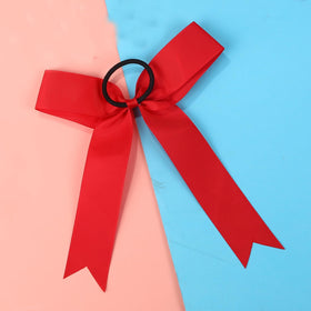 Hipcheer red bow worn in a ponytail on a teen model illustrating secure hold