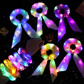 Hiwooii scrunchie in use at a party demonstrating visibility and fun nighttime style