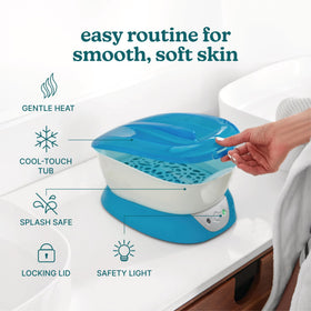 Homedics paraffin machine with hand being dipped, demonstrating comforting warm treatment