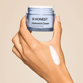 Honest Beauty applying cream to cheek showing immediate dewy finish