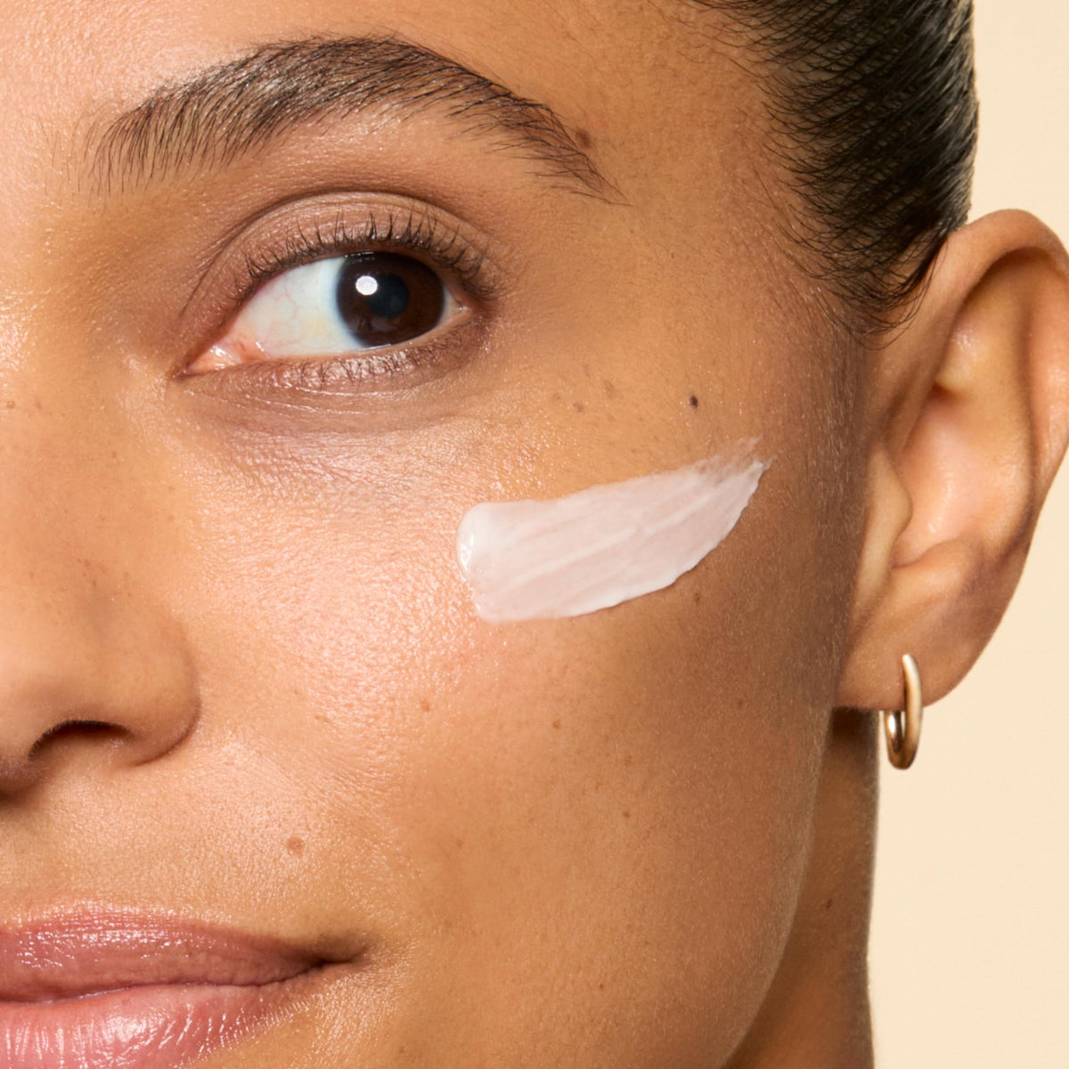 Honest Beauty open jar top view revealing pale cream and silky finish