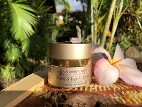 Honey Girl Organics jar held in hand showing compact size for travel benefit
