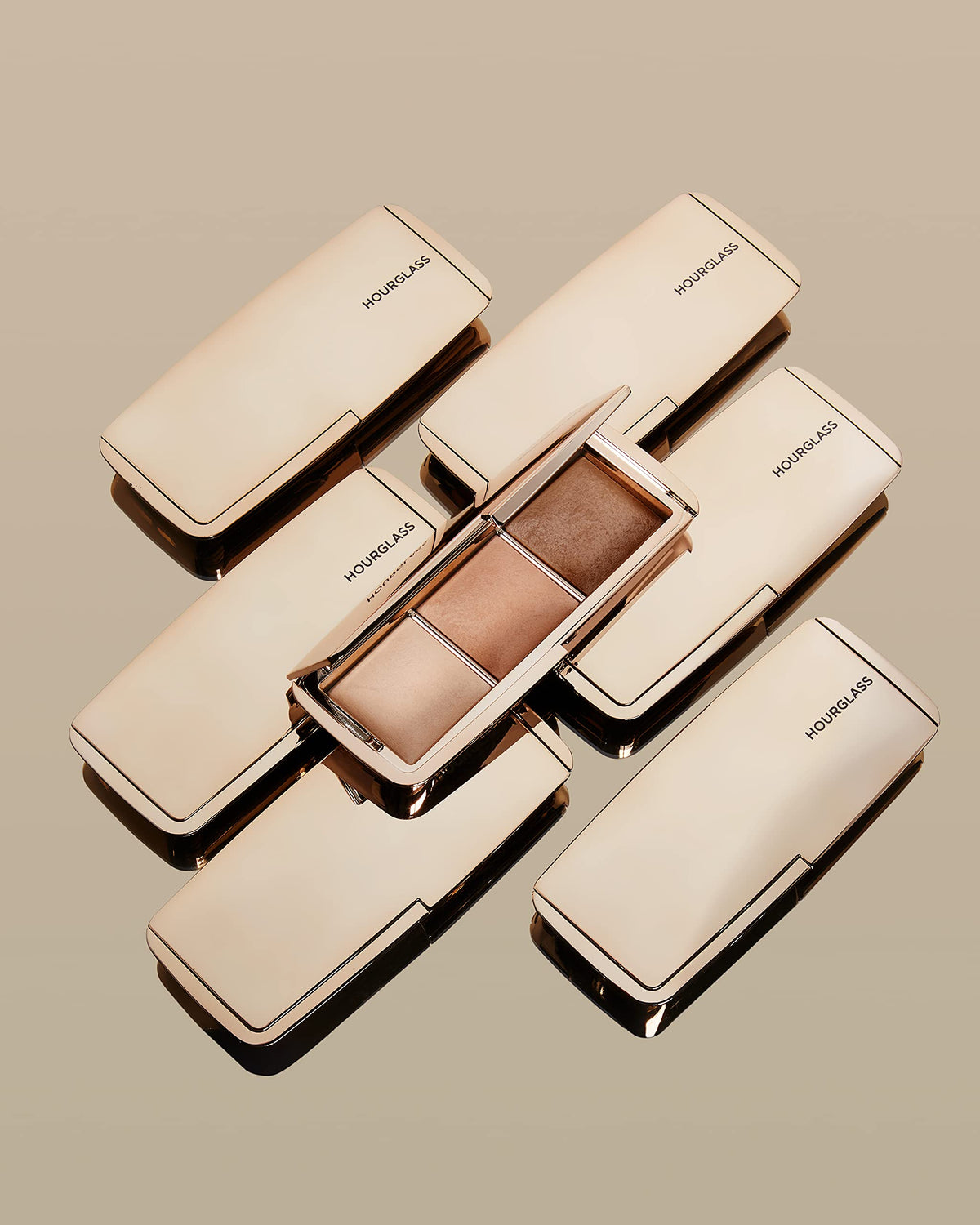 HOURGLASS palette in use applying powder to cheek for natural radiance