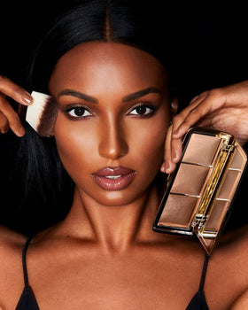 HOURGLASS palette next to coin showing compact size and travel-friendly packaging
