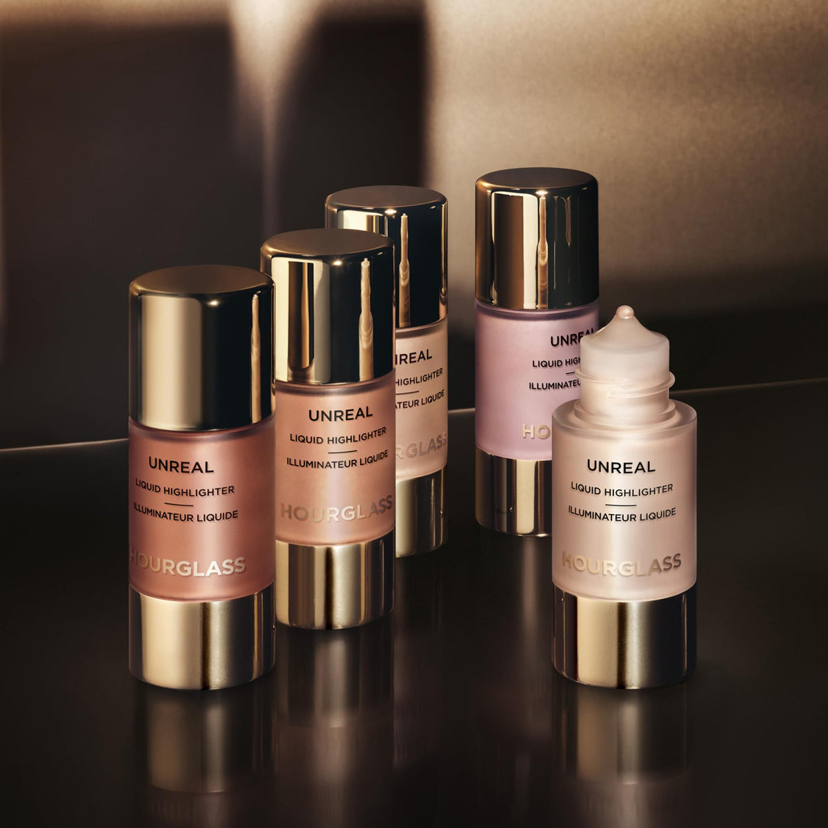 HOURGLASS bottle beside everyday cosmetics, conveys size and travel-friendly benefit