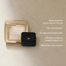 HOURGLASS pressed powder being applied from compact for quick touch-up benefit