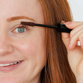 How to Be A Redhead mascara size next to coin showing compact travel-friendly design benefit