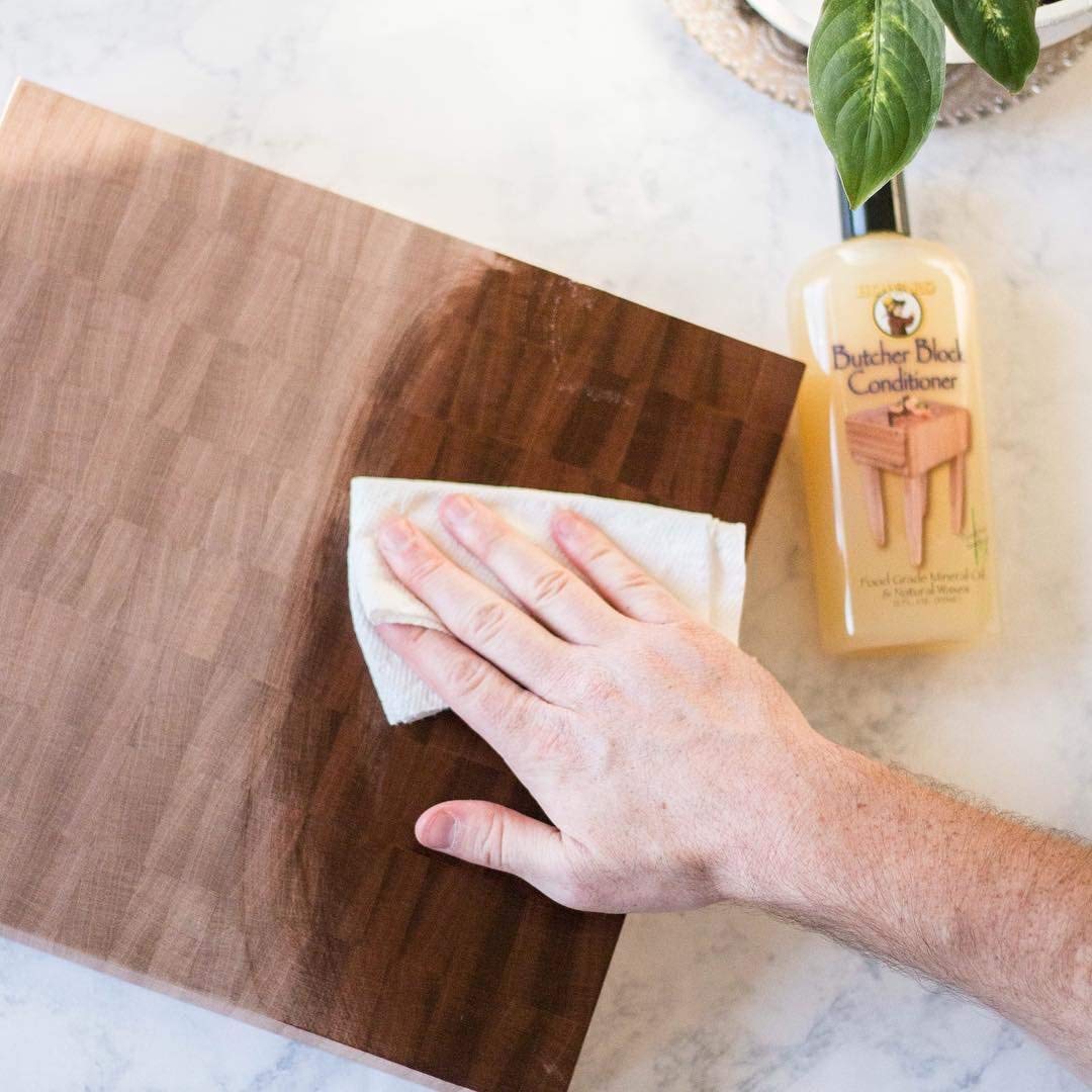 HOWARD applying conditioner to cutting board demonstrating nourishing finish