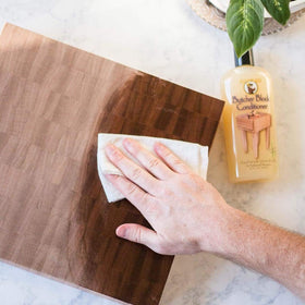 HOWARD applying conditioner to cutting board demonstrating nourishing finish