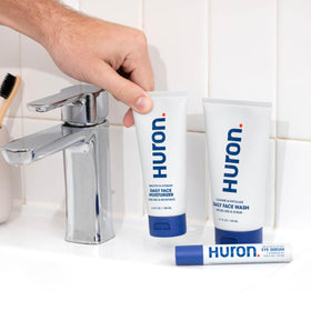 Huron moisturizer on bathroom shelf in lifestyle scene suggesting daily routine convenience