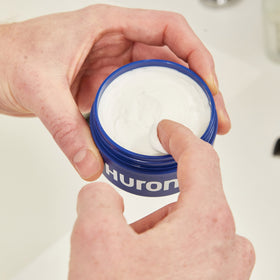 Huron size comparison in hand illustrating travel-friendly 2.7oz benefit