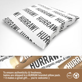 Hurraw! coconut tube in hand showing portable size and pocket-ready benefit