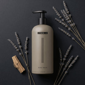HygieneLab 10 oz bottle in hand showing scale and travel-friendly benefit