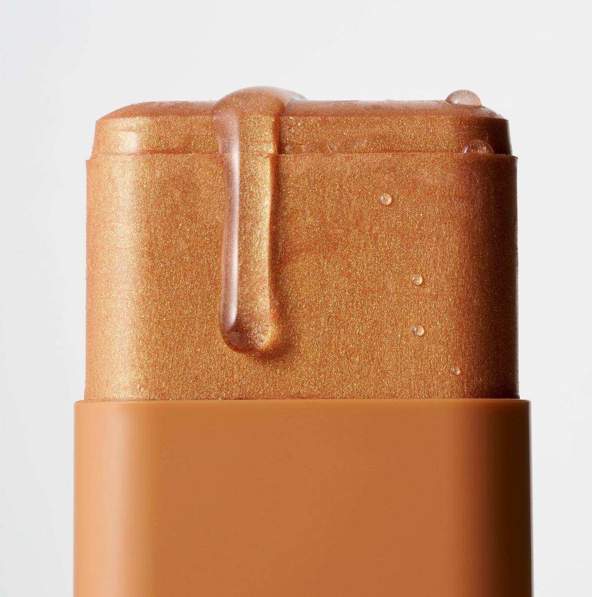 ICONIC LONDON swiped on shoulder for body glow, highlights dewy finish