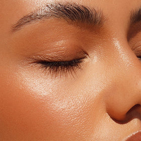 ICONIC LONDON close-up of balm texture melting, shows creamy sheen benefit