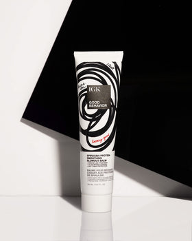IGK in-use blow-dry styling scene showing controlled blowout and heat-activated smoothing benefit