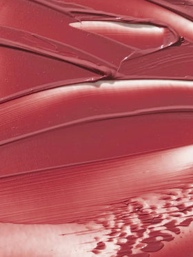 ILIA technician hand-pouring balm highlighting artisanal texture consistency benefit