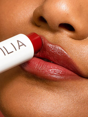 ILIA product in natural light emphasizing soft shine and dewy finish on lips