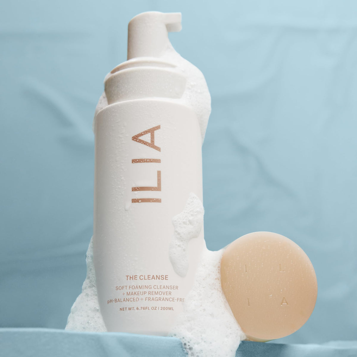 ILIA bottle with dispensed foam illustrating easy application and cleansing