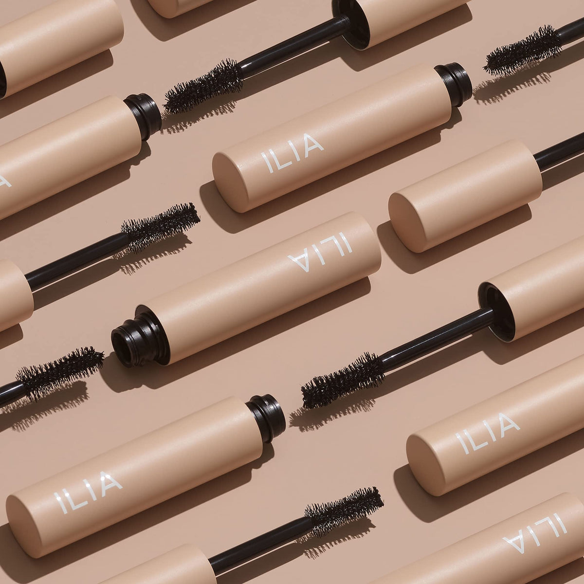 ILIA mascara beside a coin to show compact 0.32 fl oz scale