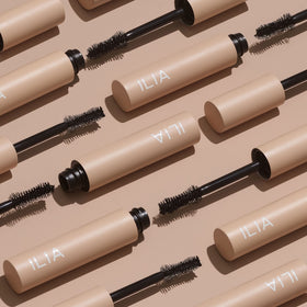 ILIA mascara beside a coin to show compact 0.32 fl oz scale