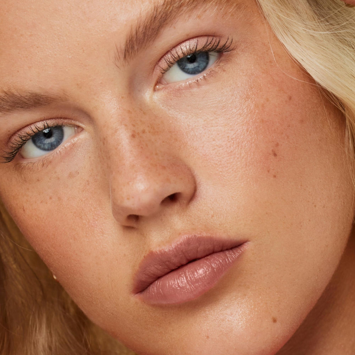 ILIA application on lips showing neutral beige Untitled shade and natural enhancing effect