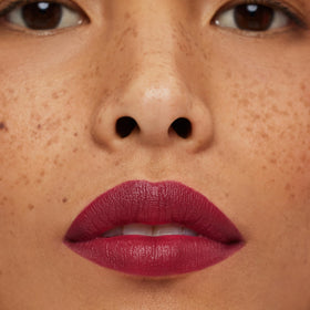 ILIA swatches on skin showing true deep magenta color payoff