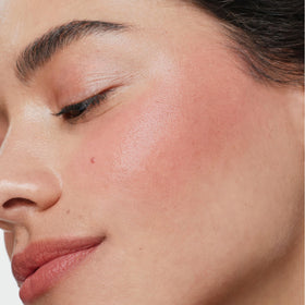 ILIA applying multi-stick to cheek for instant fresh color