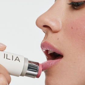 ILIA stick applied to cheeks showing natural flush and quick blending benefit