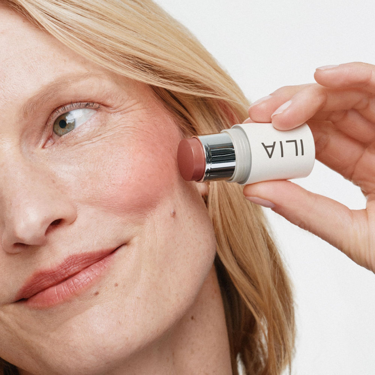 ILIA applied on cheeks demonstrating natural glow and instant freshening effect