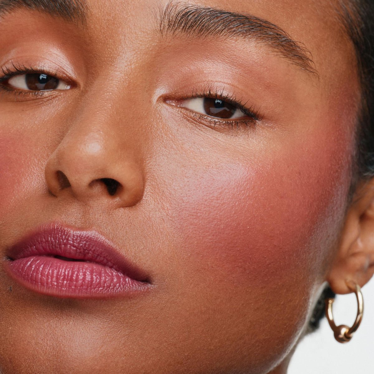 ILIA multi-stick on lips showing rich berry color and conditioning feel