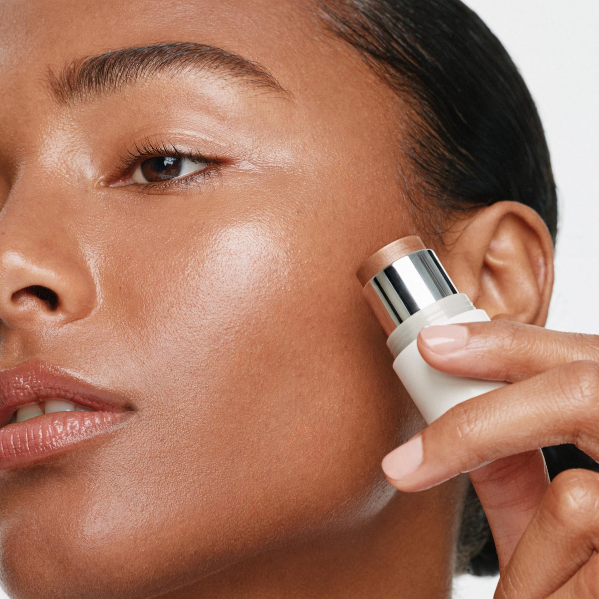 ILIA closeup on lips showing luminous bronze pearl finish and nourishing comfort