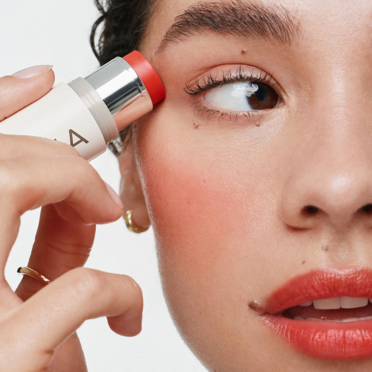 ILIA multi‑stick swatch on skin showing blendable pigment and luminous finish