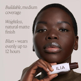 ILIA size comparison with coin to show compact tube dimensions for portability