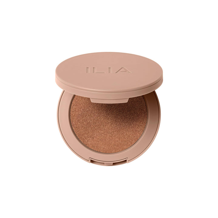ILIA compact front view showing bronzer pan and sleek packaging benefit of travel-ready design