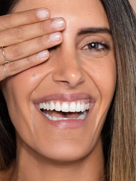 ILIA applied on model with medium skin, shows natural dewy coverage