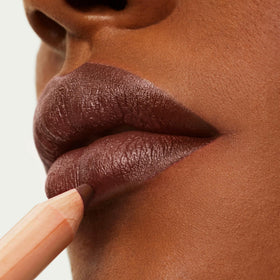 ILIA applied on lips in studio lighting demonstrating even coverage and soft-matte look