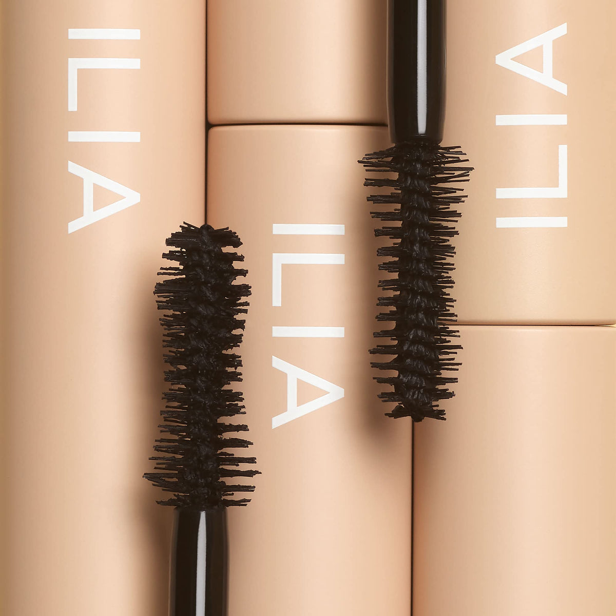 ILIA travel-size mascara in hand for compact portability