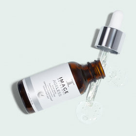 IMAGE Skincare serum on bathroom counter during nighttime routine showing layering benefit