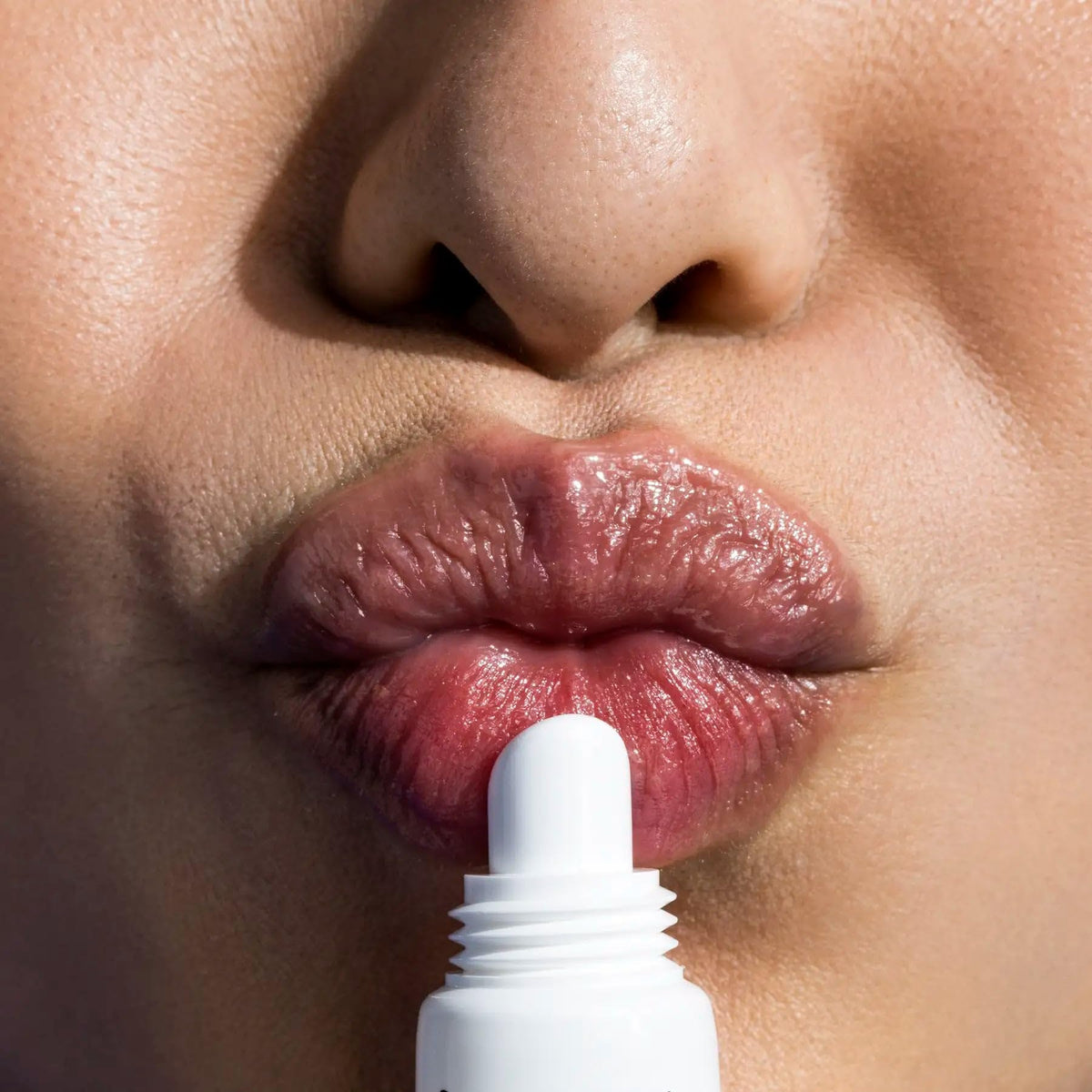 IMAGE Skincare lip balm in hand to show compact, travel-friendly size