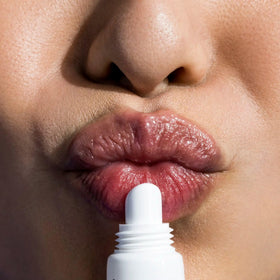 IMAGE Skincare lip balm in hand to show compact, travel-friendly size