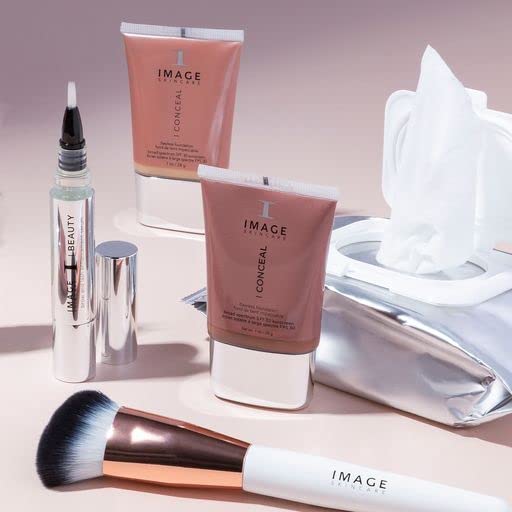 IMAGE Skincare pack next to a smartphone showing compact travel-friendly size