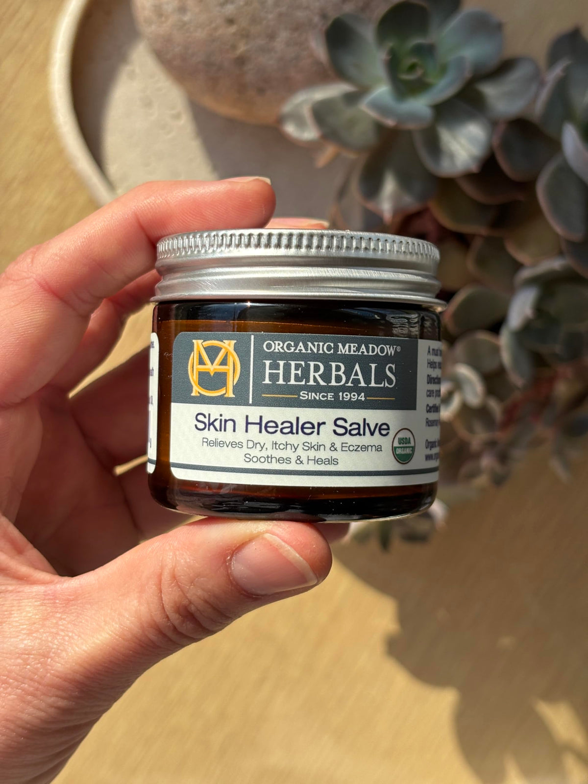 Applying Indian Meadow Herbals salve to dry skin for soothing barrier protection