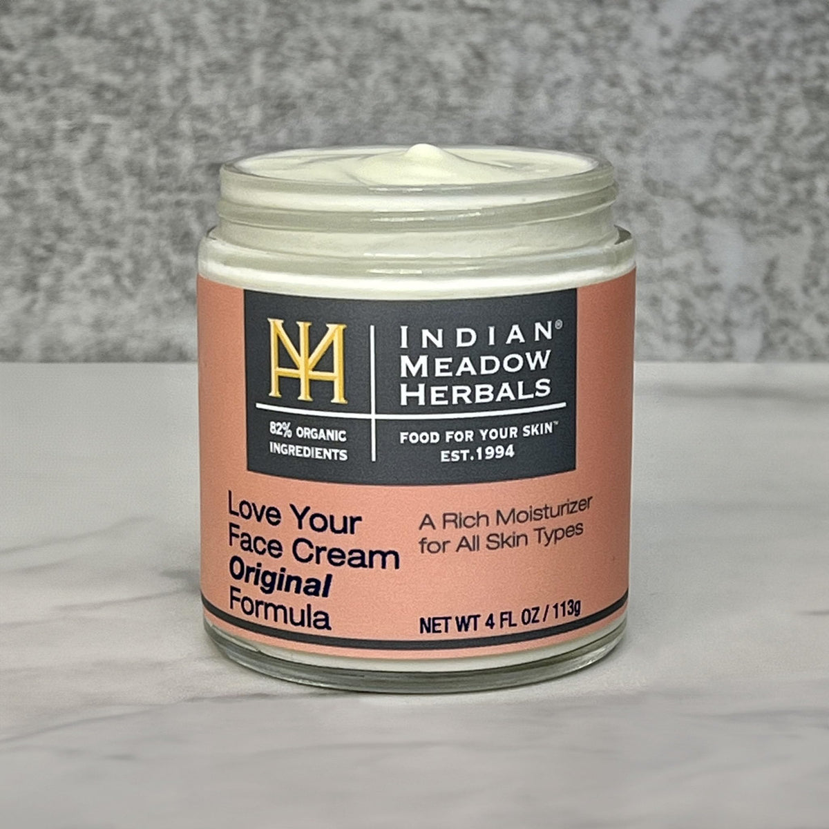 Indian Meadow Herbals jar beside natural ingredients flatlay emphasizing organic content